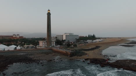 Aerial-shot-of-the-coast-with-resort-and-lighthouse