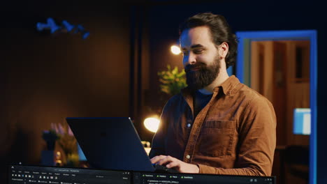 Portrait-of-smiling-man-doing-IT-support-job-from-home,-standing-in-office