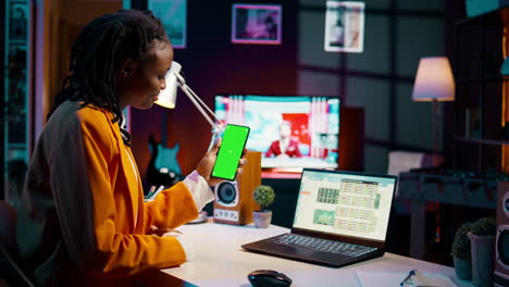 Young-woman-working-with-financial-spreadsheet-and-greenscreen