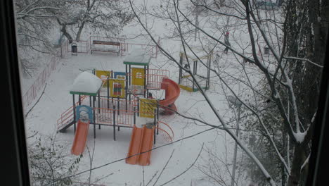 Friends-playing-together-at-playground-in-winter