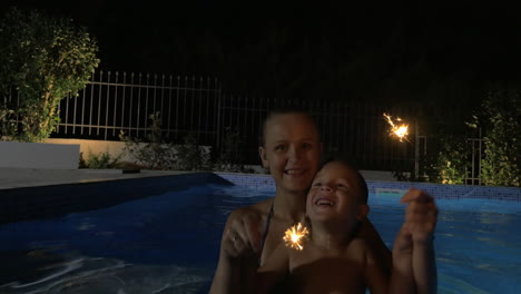 Woman-and-Boy-with-Sparklers-in-Pool
