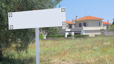 Blank-advertising-sign-in-front-of-the-houses