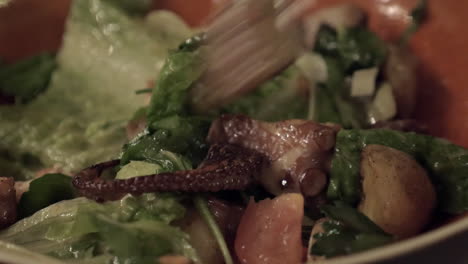 Eating-salad-with-octopus-and-vegetables