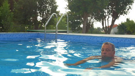 Hombre-Maduro-Relajándose-Nadando-En-La-Piscina.