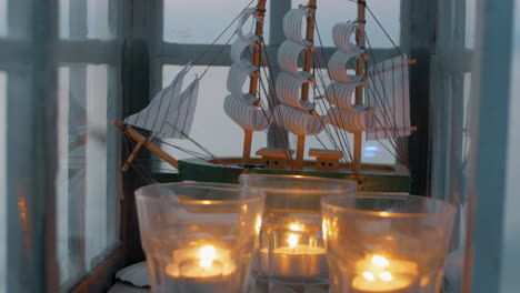 Outdoor-lantern-with-ship-model-and-candles