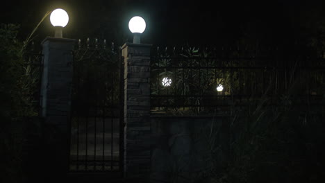 View-on-illuminated-gates-made-of-stone-and-metal