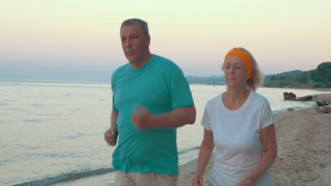 Mature-Couple-Jogging-on-the-Beach