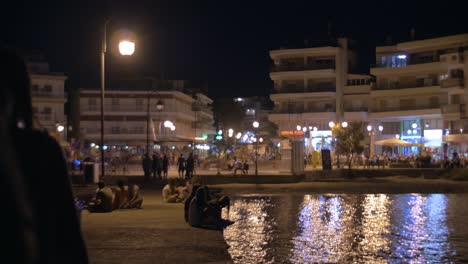 Pier-and-city-square-with-people-at-night