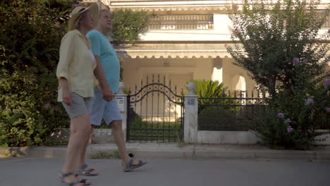 Couple-of-tourists-walking-by-private-houses