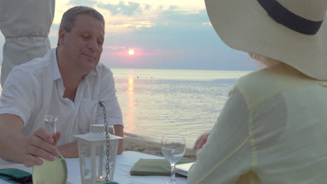 Mature-couple-enjoying-evening-on-the-seashore