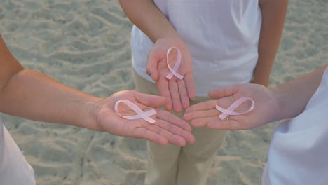 Three-women-with-pink-awareness-ribbons