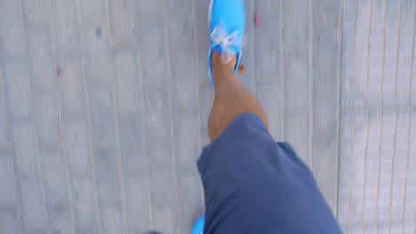 Man-walking-down-the-street-in-blue-moccasins