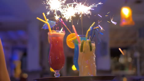 Waitress-carrying-cocktails-with-sparklers