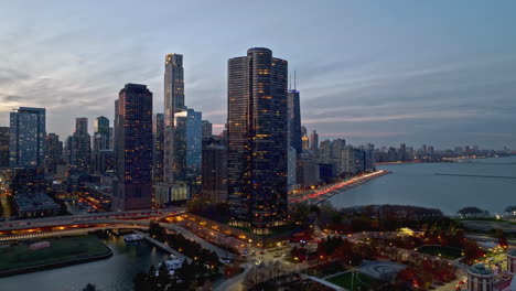 Aerial-view-around-the-Lake-Point-Tower,-colorful-fall-dusk-in-Chicago,-USA