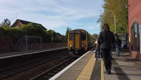 Northern-rail-train-pulling-up-at-Urmston-station-on-Liverpool-to-Manchester-line-UK