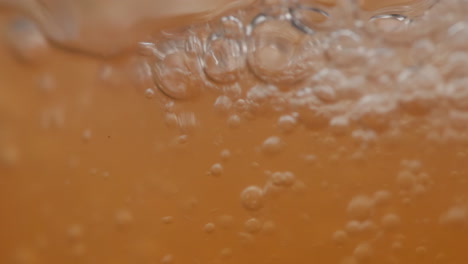 Fizzy-Orange-Carbonated-Soda-Filling-A-Glass,-Macro-Close-Up