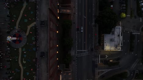 Top-view-of-Ponce-City-Market-street-and-rooftop-amusement-park-at-dusk,-American-city-at-night