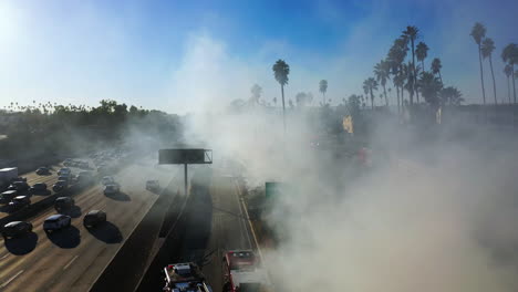 Aerial-view-of-the-nature-smoking,-urban-fire-near-the-Santa-Monica-freeway-in-LA