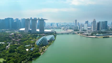 Drone-Shot-Of-Singapore-Green-Gardens-At-Beautiful-Bay,-Skyline-City-In-Background