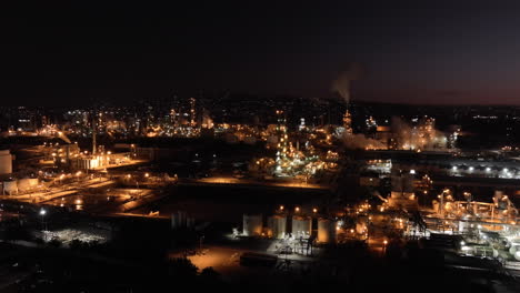 San-Pedro,-California-oil-refinery-and-industrial-area-at-nighttime---ascending-aerial