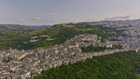 Ragusa-Italy-Aerial-v3-panoramic-view-drone-flyover-the-valley-around-historic-hillside-town-of-Ibla-capturing-Duomo-di-San-Giorgio-cathedral-church-nestled-within---Shot-with-Mavic-3-Cine---June-2023