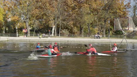 Group-of-young-people-practicing-kayak-pole-or-canoe-pole-on-a-lake-in-the-park-of-casa-de-campo-in-Madrid