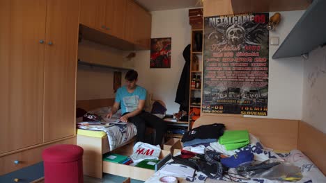 A-young-man-is-working-hard-to-put-everything-in-order-and-tidy-up-his-room
