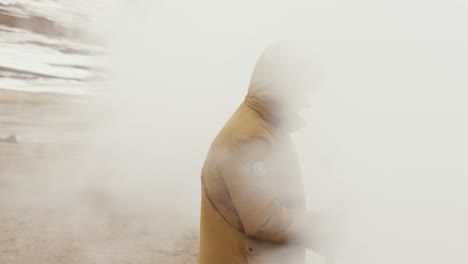 Videographer-prepare-himself-to-go-into-white-dense-vapor-cloud,-Iceland