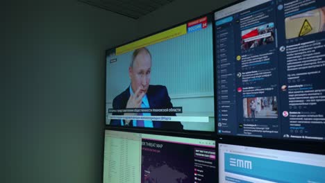 Handheld-shot-of-screens-with-data-and-analyses-approaching-Russian-president-Putin-till-abstract-closeup