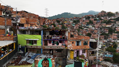 Aerial-view-toward-people-on-a-ghetto-house-balcony-in-Comuna-13,-Colombia