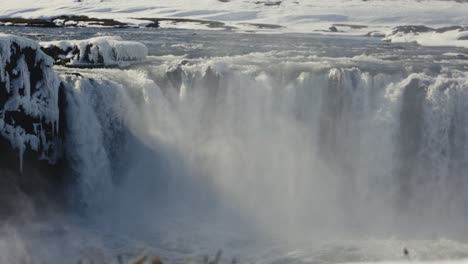 Reveal-of-Godafoss-waterfall-pool-during-bright-Icelandic-winter-day