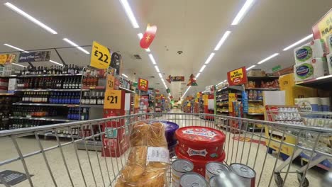 POV-supermarket-shopping-cart-walking-down-alcohol-grocery-products-aisle