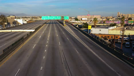 Drone-shot-approaching-a-person-walking-on-the-shut-down-Interstate-10,-in-LA,-USA
