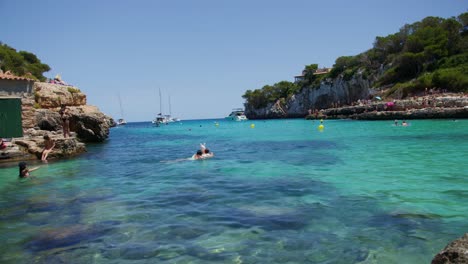 Mallorca:-Beach-Side-View-Of-Resort-In-Cala-Liombards-On-Majorca-Island,-Spain,-Europe-|-Women-In-Bikinis