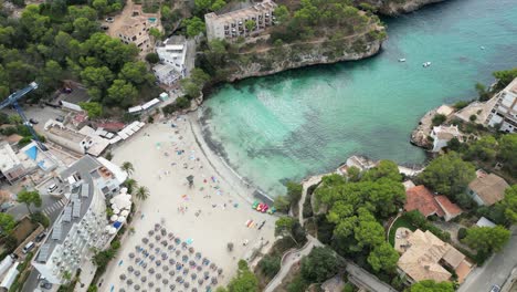 East-coast-of-Mallorca-during-the-summer-on-a-white-sand-beach,-aerial