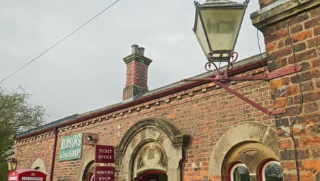 Vintage-British-railway-station-platform-office-building-pan-down-reveal