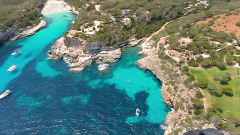 Mallorca:-Aerial-View-Of-Resort-Town-Cala-Liombards-On-Majorca-Island,-Spain,-Europe-|-Ocean-Follow-to-Exotic-Beachside-Mansions