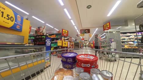 POV-supermarket-shopping-cart-walking-down-chilled-grocery-products-aisle