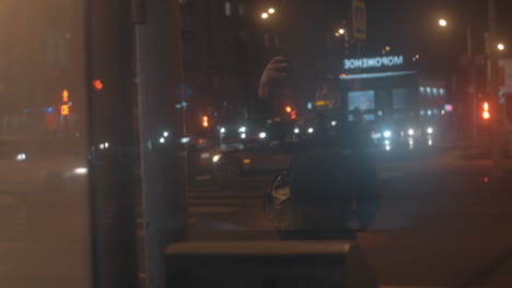 Woman-taking-selfie-against-night-city