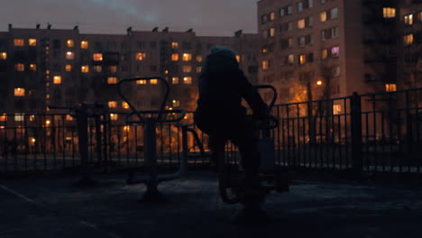 Kid-on-street-exercise-bike-in-the-dusk