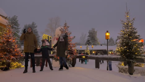 Mom-dad-and-son-in-the-park-decorated-with-Christmas-lights