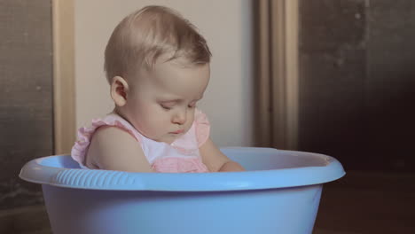 Cute-baby-girl-in-a-round-blue-tub-2