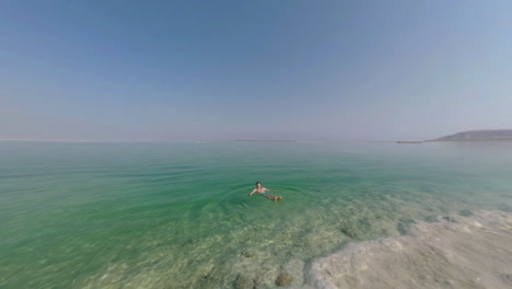 Man-swimming-in-pure-salt-water-of-Dead-Sea-Israel