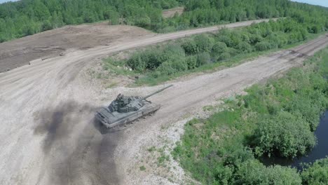 Flying-over-tank-driving-on-rough-ground-in-the-woods