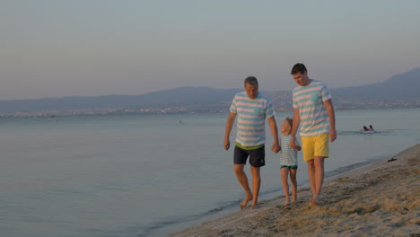 Child-father-and-grandfather-walking-on-the-beach