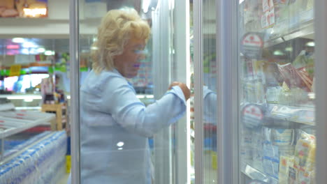 Woman-buying-food-in-fridge-dairy-section