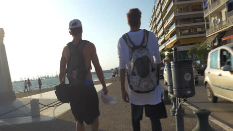 Two-guys-walking-in-resort-city