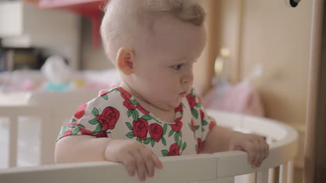 Cute-baby-girl-in-a-round-crib-1