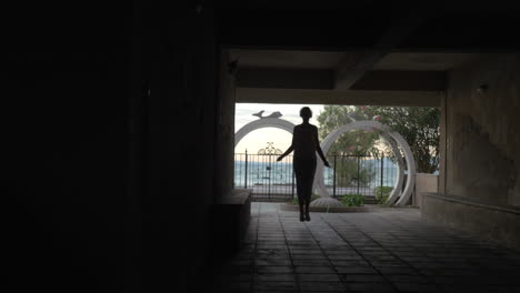 Woman-in-headphones-skipping-rope-in-the-yard