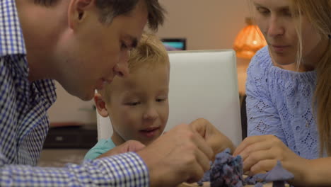 Son-and-parents-playing-with-plasticine